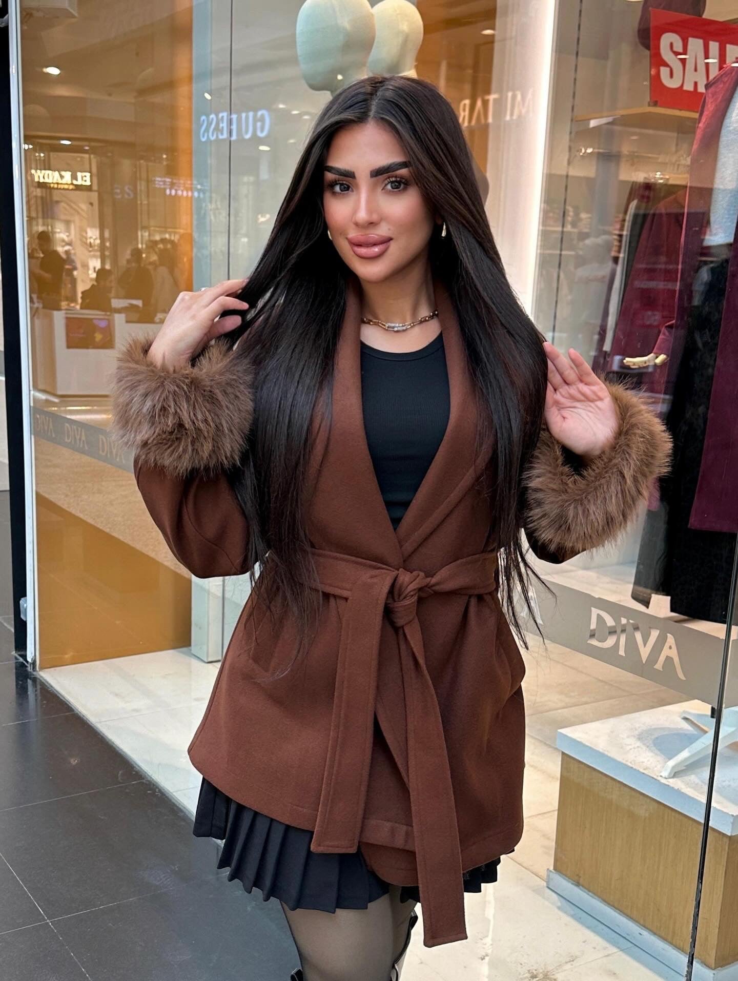 Short wool coat with fur around the sleeves