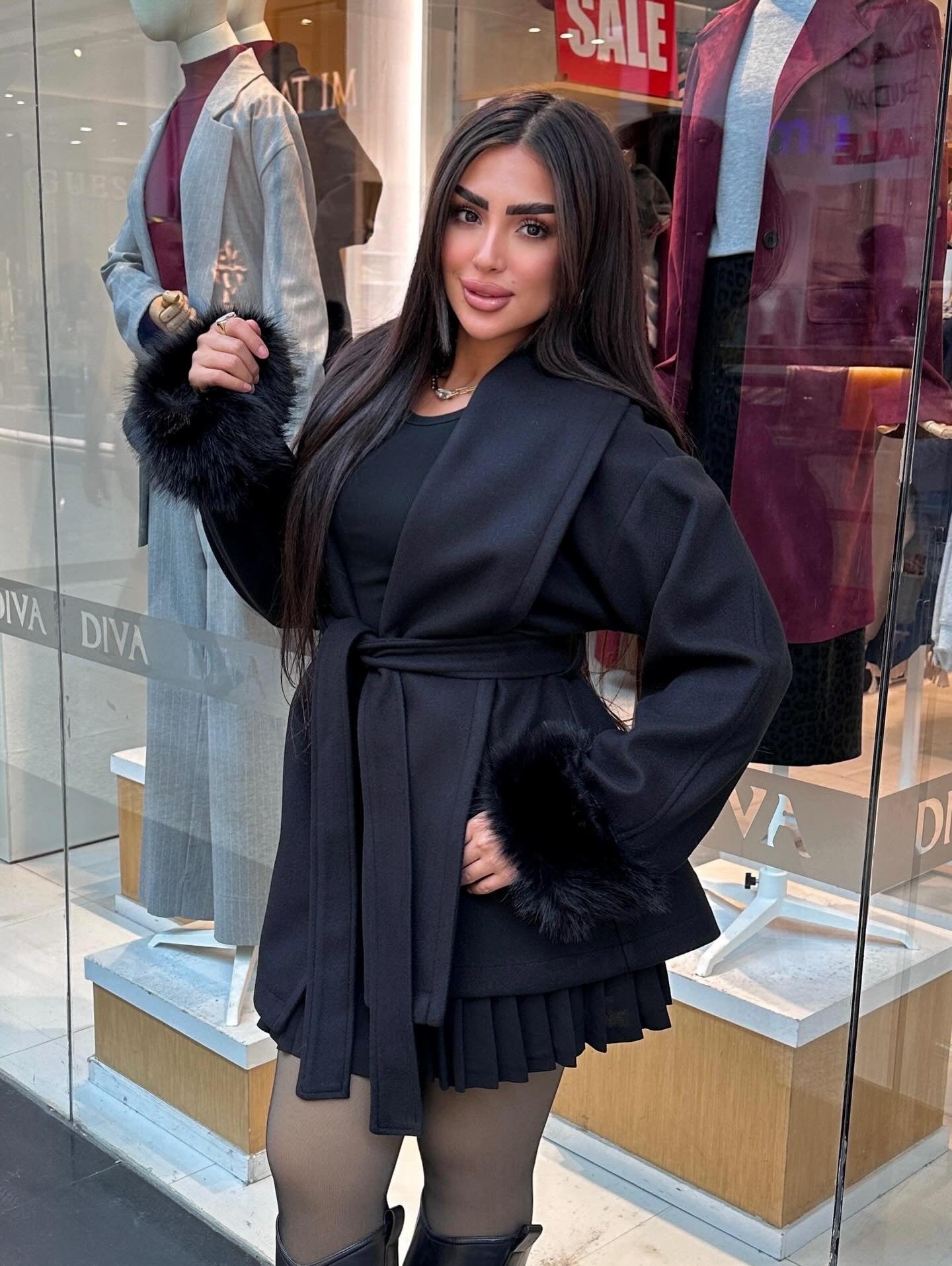 Short wool coat with fur around the sleeves